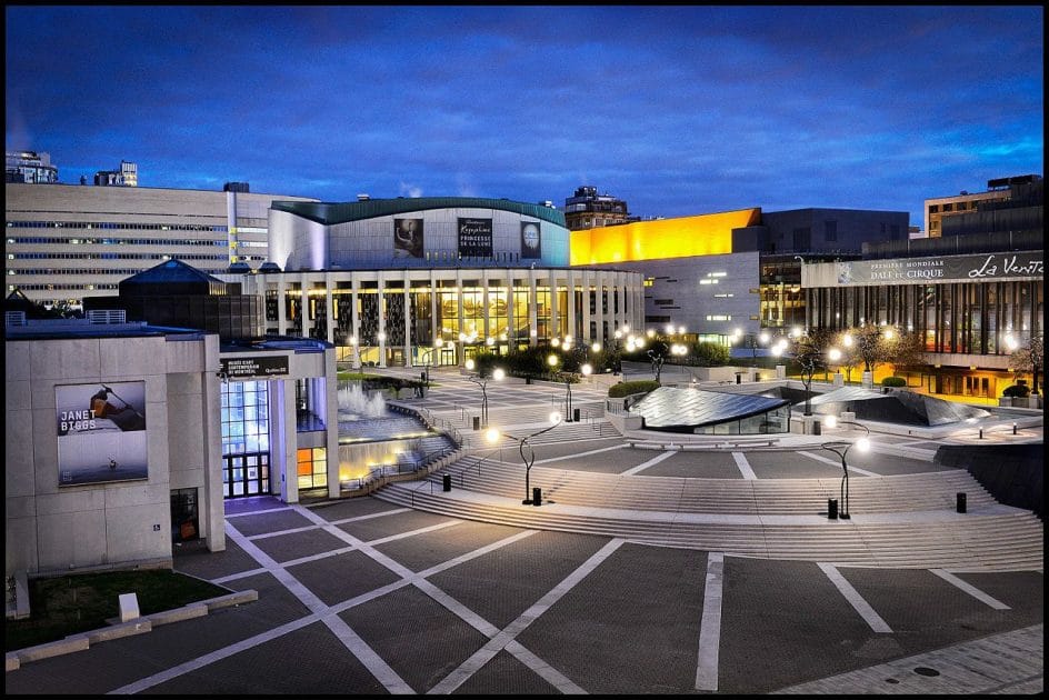 a large building with a fountain and a fountain in front of it